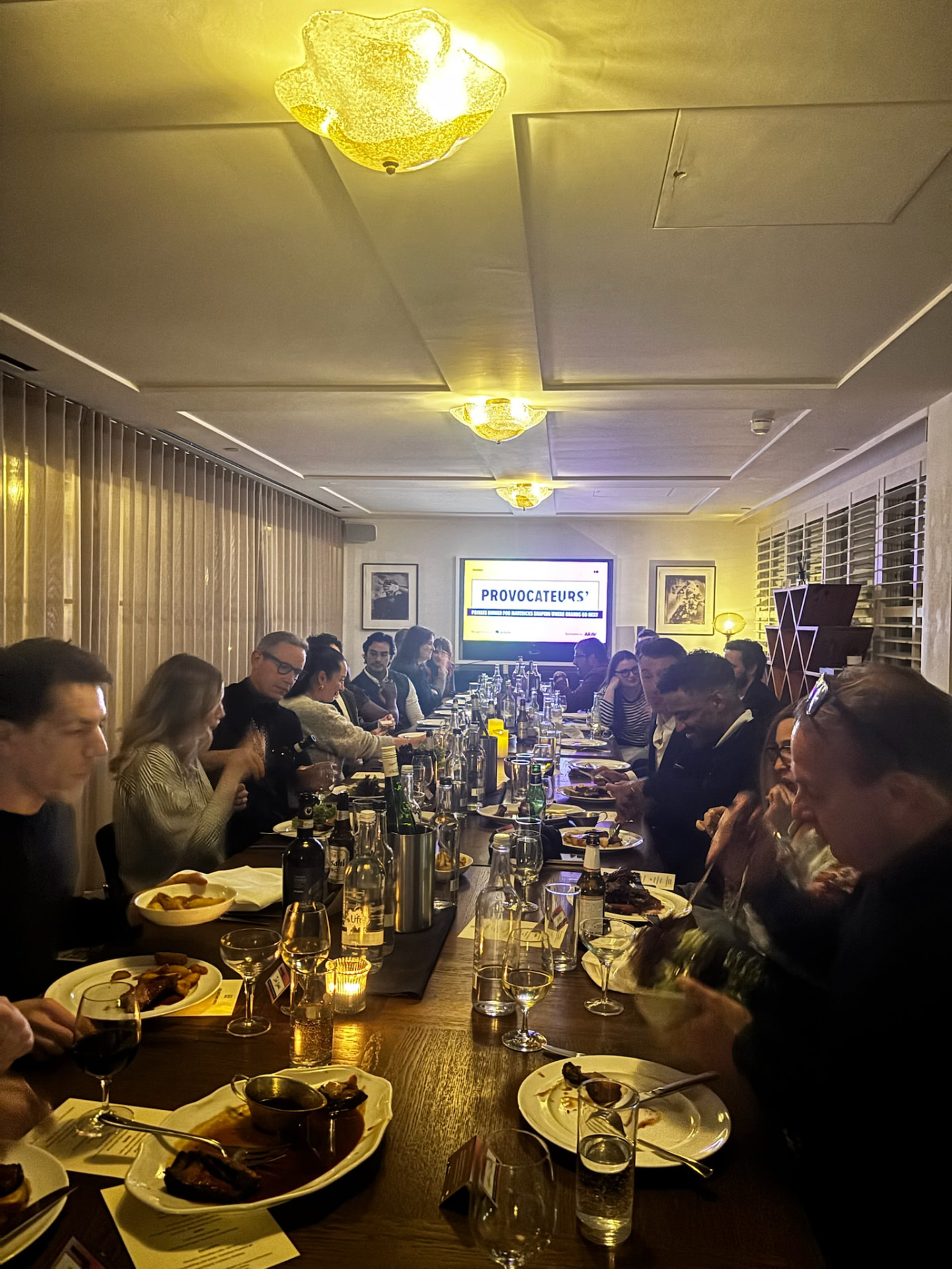 Guests gathered around the Provocateurs' Dinner table